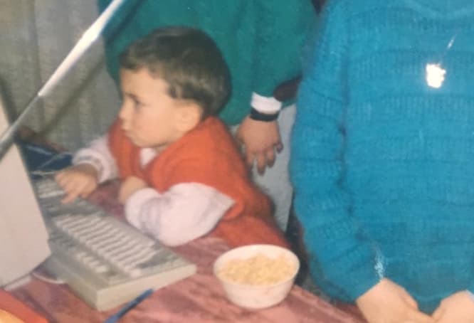 Emre Elbeyoglu as a four-year-old at a computer keyboard in 1993