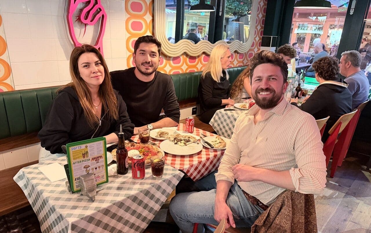 Emre Elbeyoglu with Batuhan Ozyon and a friend over pizza at Pizza Pilgrims in London